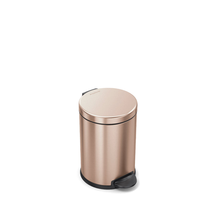Angled view of Simplehuman 4.5L Round Step Can in Rose Gold, hands-free pedal operation.