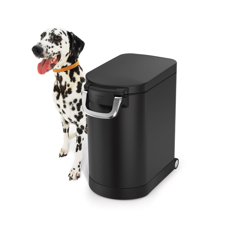 Simplehuman Medium Pet Food Can, Matte Black, studio view with dog, secure locking handle and wheels.