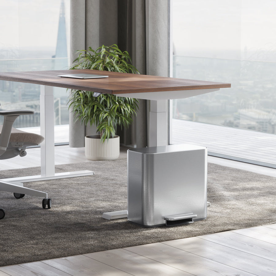 Simplehuman Brushed Stainless Steel 15L Mini Recycler Step Can under a desk, space-saving design with hands-free foot pedal.