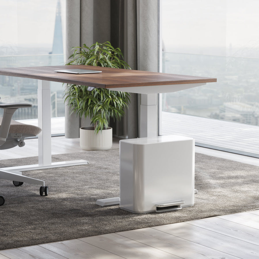 Simplehuman White 15L Mini Recycler Step Can under a modern office desk, hands-free pedal for dual waste separation.