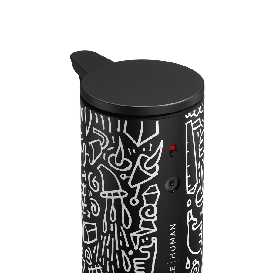 Close-up detail of Simplehuman 9 oz. Sensor Pump in Black Doodle Graphic, showing power switch and adjustable dosage dial.