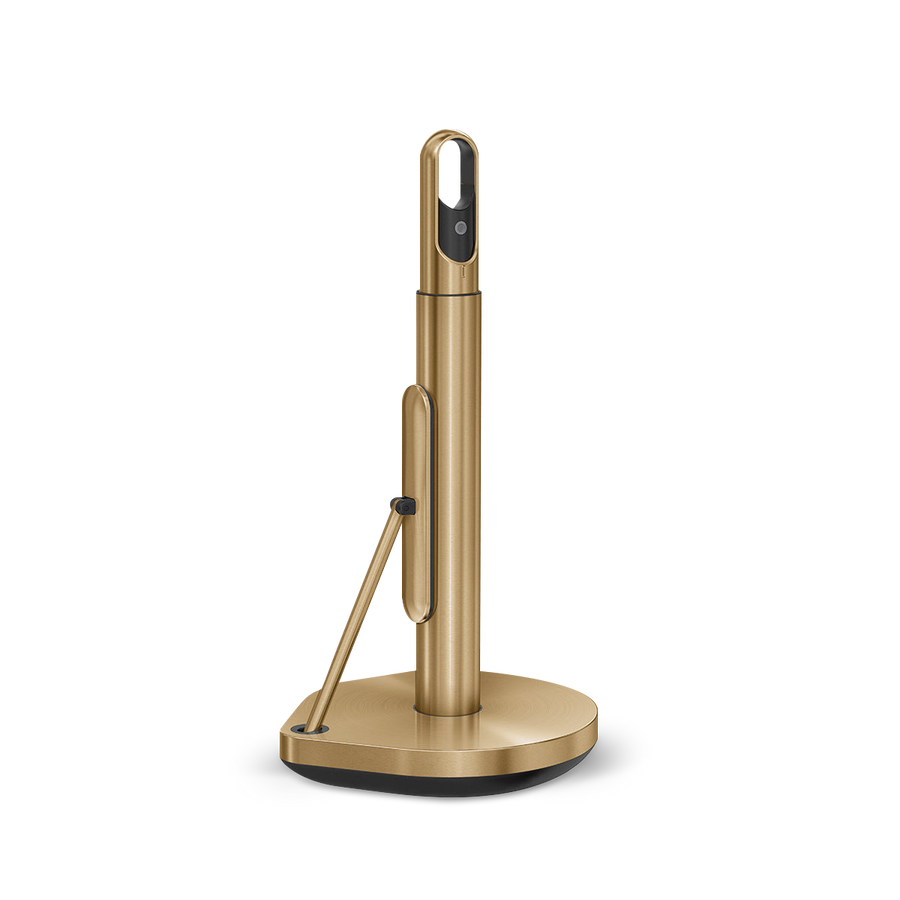 Angled view of Simplehuman Brass Paper Towel Holder, showing quick-tear arm and spray handle storage.