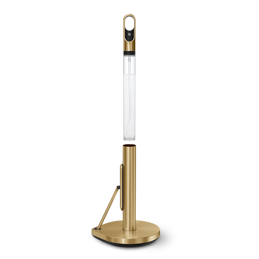 Detail view of Simplehuman Brass Paper Towel Holder, showing integrated spray bottle storage and quick-tear arm.