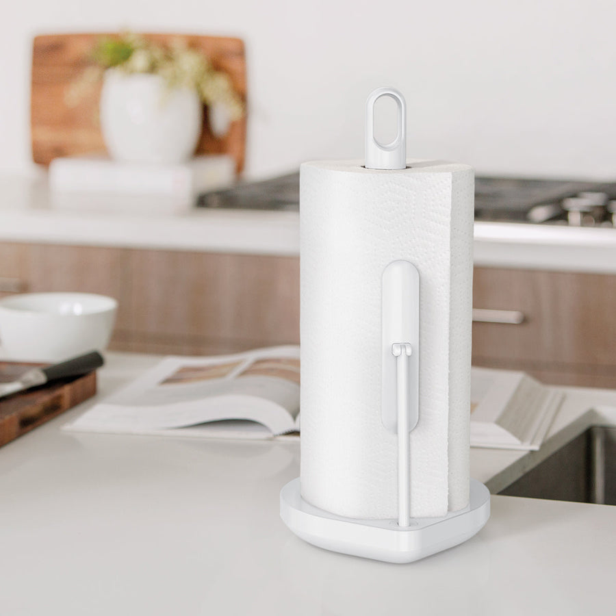 Simplehuman White Tension Arm Paper Towel Holder on kitchen counter, weighted base enables one-handed tear.