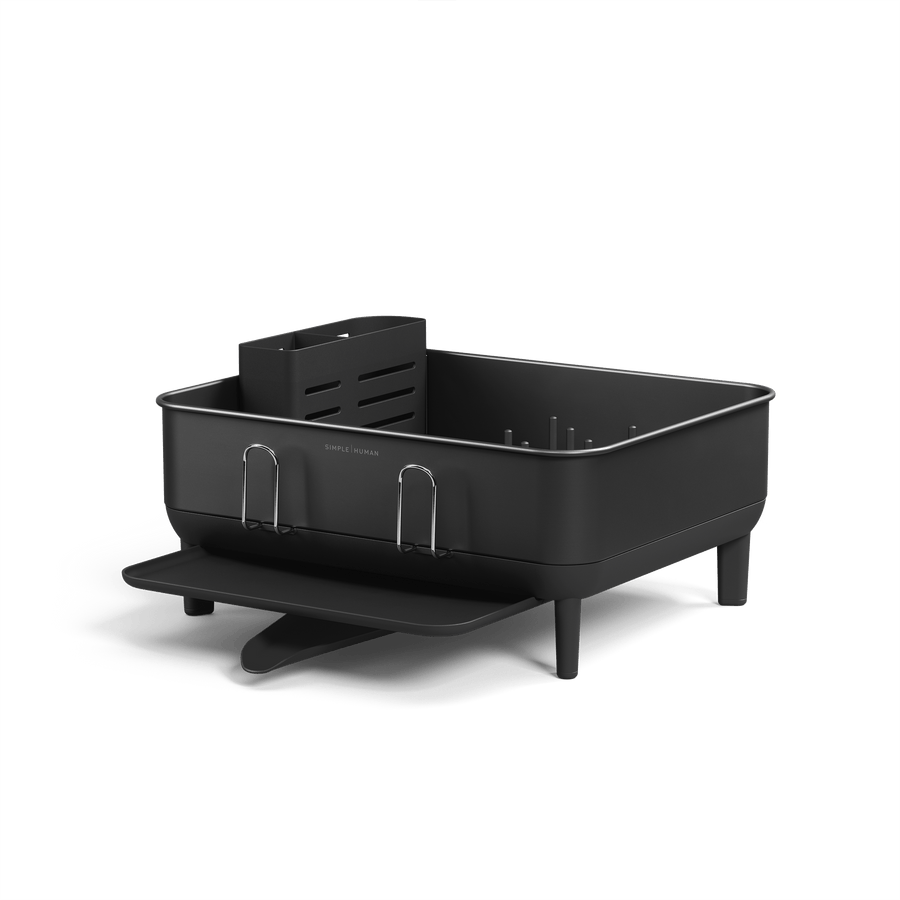 Angled view of Simplehuman Compact Steel Frame Dishrack, Matte Black, featuring removable caddy and polished steel cup rack.