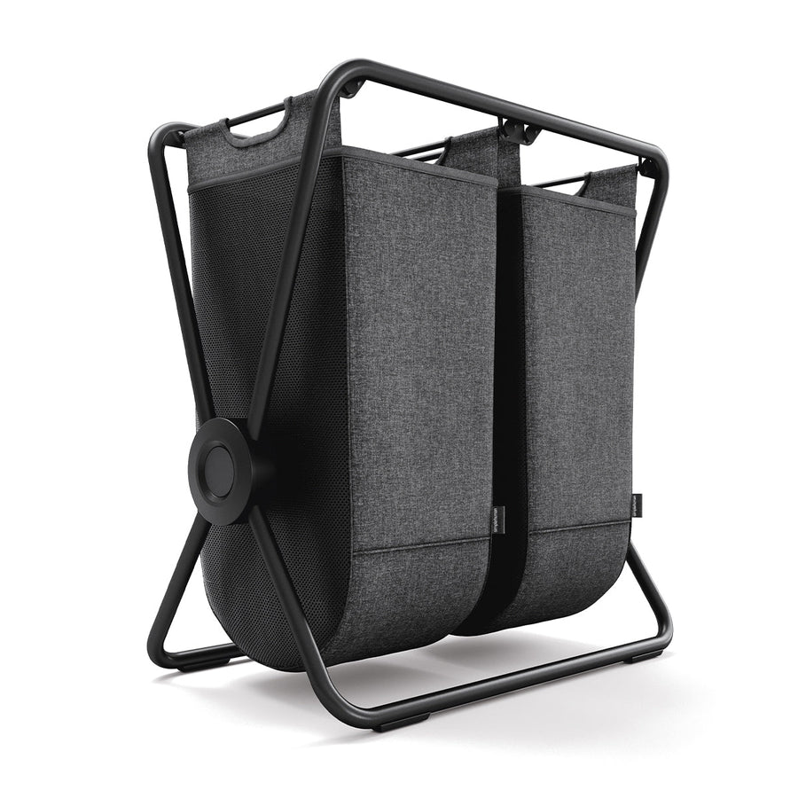 Angled view of Simplehuman Double X-Frame Hamper, Black frame, dual dark gray removable liners for sorting.