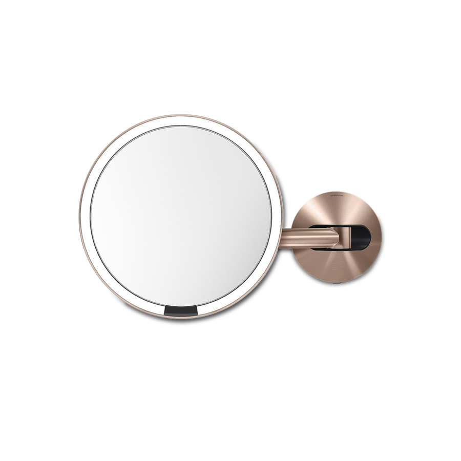 Front view of Simplehuman Hard-Wired Wall Mount Sensor Mirror in Rose Gold, adjustable arm, touch-free sensor light.