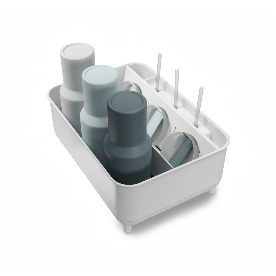 Angled view of Simplehuman White Bottle Dock holding 3 reusable bottles in assorted colors with straws and lids.