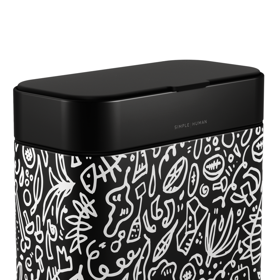 Close-up of Simplehuman Matte Black Compost Caddy with white doodle pattern, showing the tight, odor-proof seal and branding.