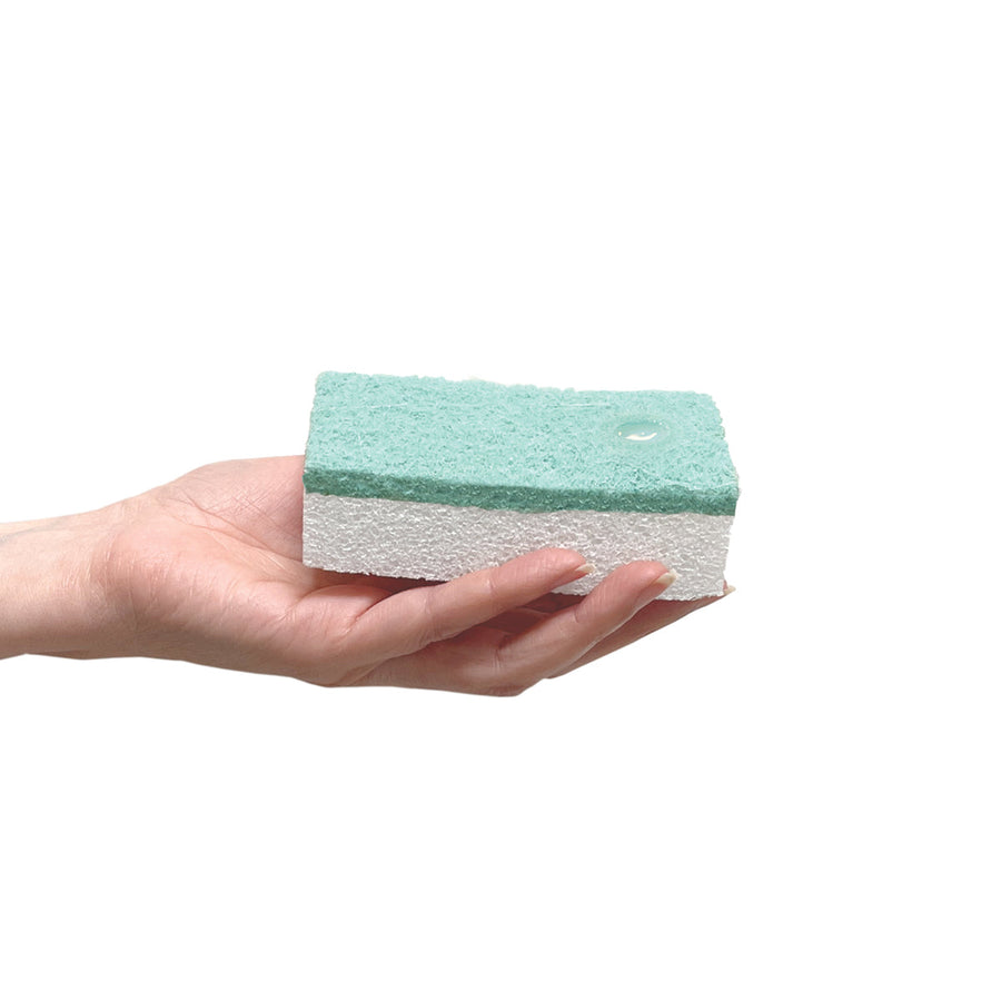 Close-up of Simplehuman Liquid Dish Soap drop on a sponge in hand, demonstrating usage.