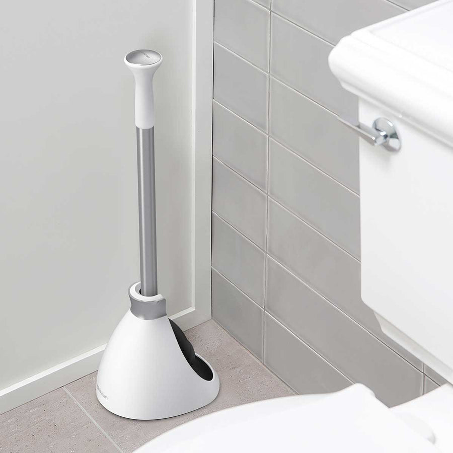 Simplehuman White Toilet Plunger, space-saving design with self-closing caddy, stored hygienically by the toilet.