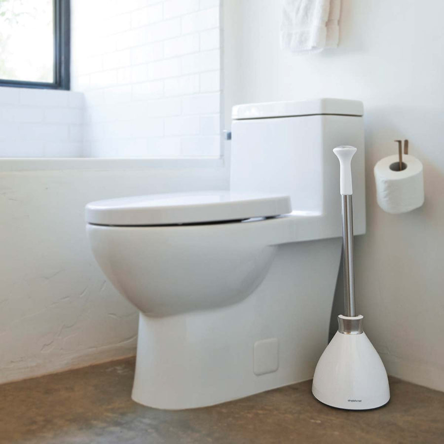 Usage view of Simplehuman White Toilet Plunger, Stainless Steel handle and self-closing caddy, stored hygienically by toilet.