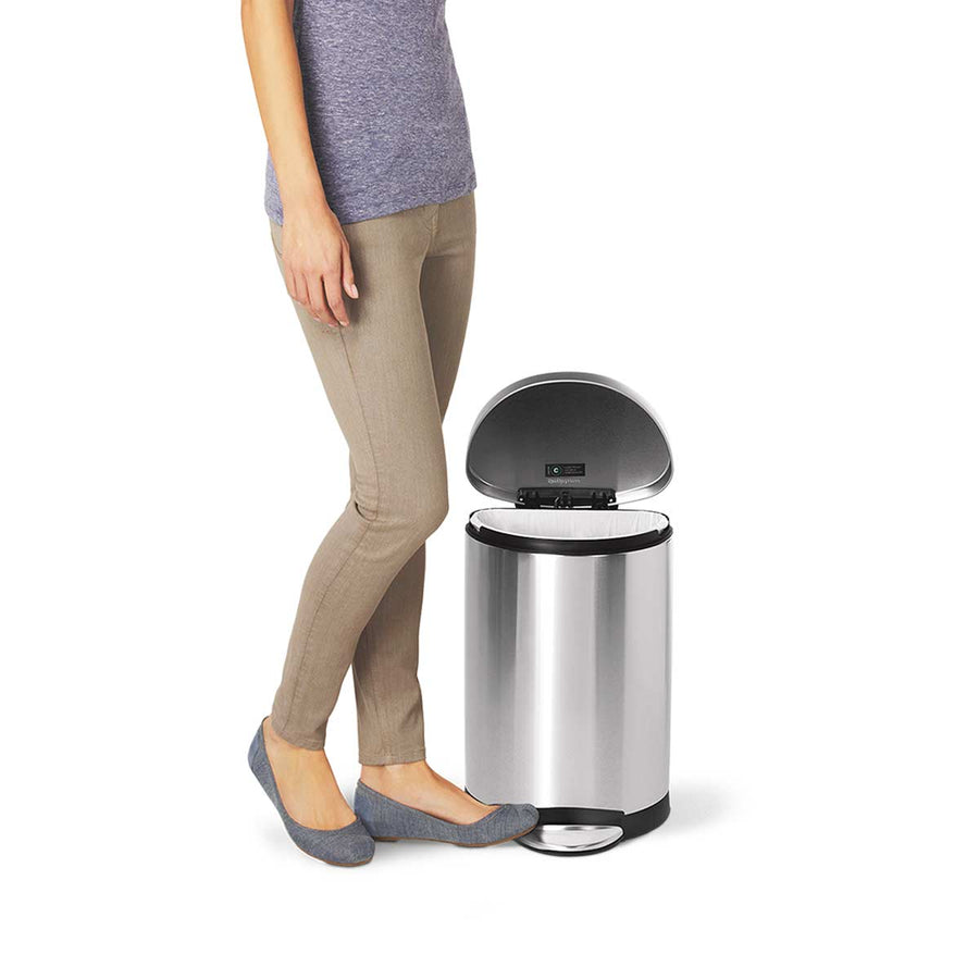 Lifestyle view of Simplehuman 10L Semi-Round Step Can, Brushed Stainless Steel, demonstrating hands-free operation.