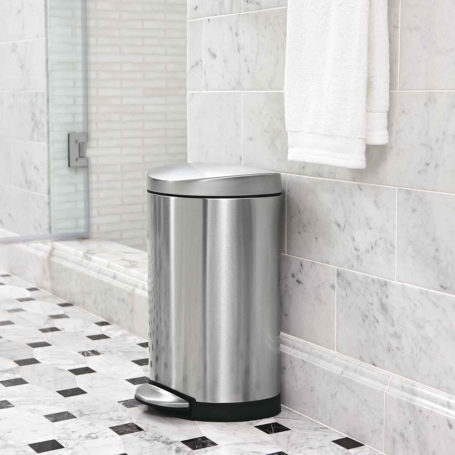 Simplehuman 10L Semi-Round Step Can, Brushed Stainless Steel, in a modern marble bathroom, hands-free operation.