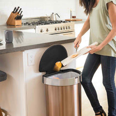 45L semi-round sensor can - rose gold finish - lifestyle scraping food into trash can in kitchen